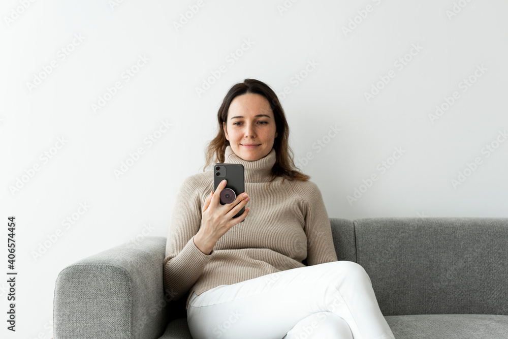 Round phone grip behind the mobile with woman using the phone