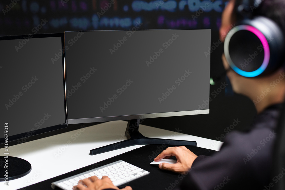 Male IT programmer working on blank screen computer