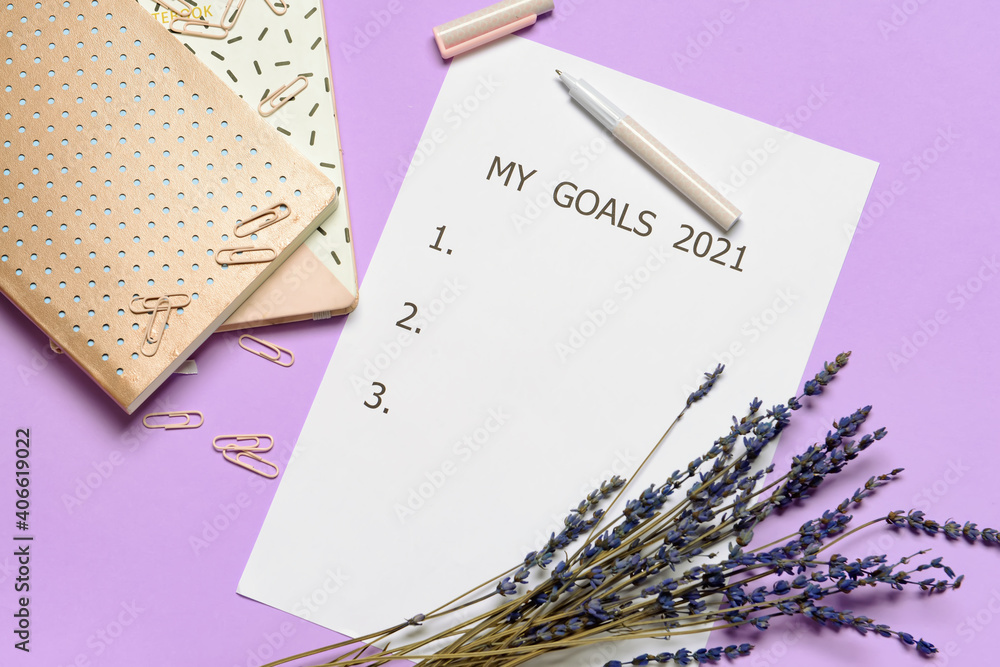 Paper sheet with text MY GOALS 2021, lavender and stationery on color background