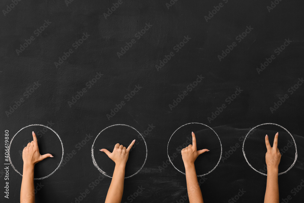 Female hands showing different time on dark background