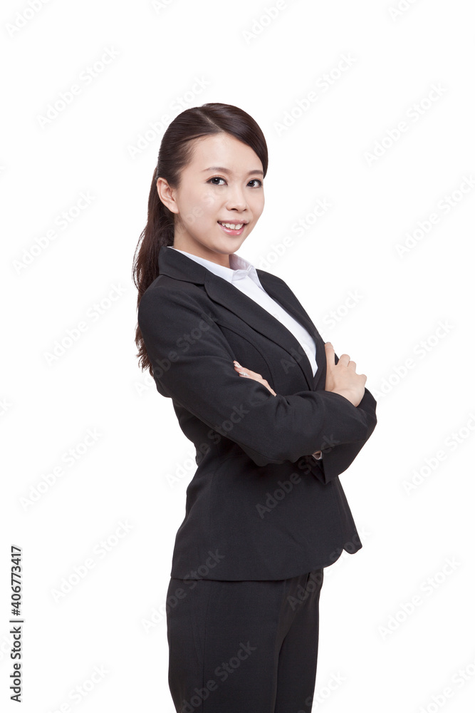 Portrait of young businesswoman standing folding arms