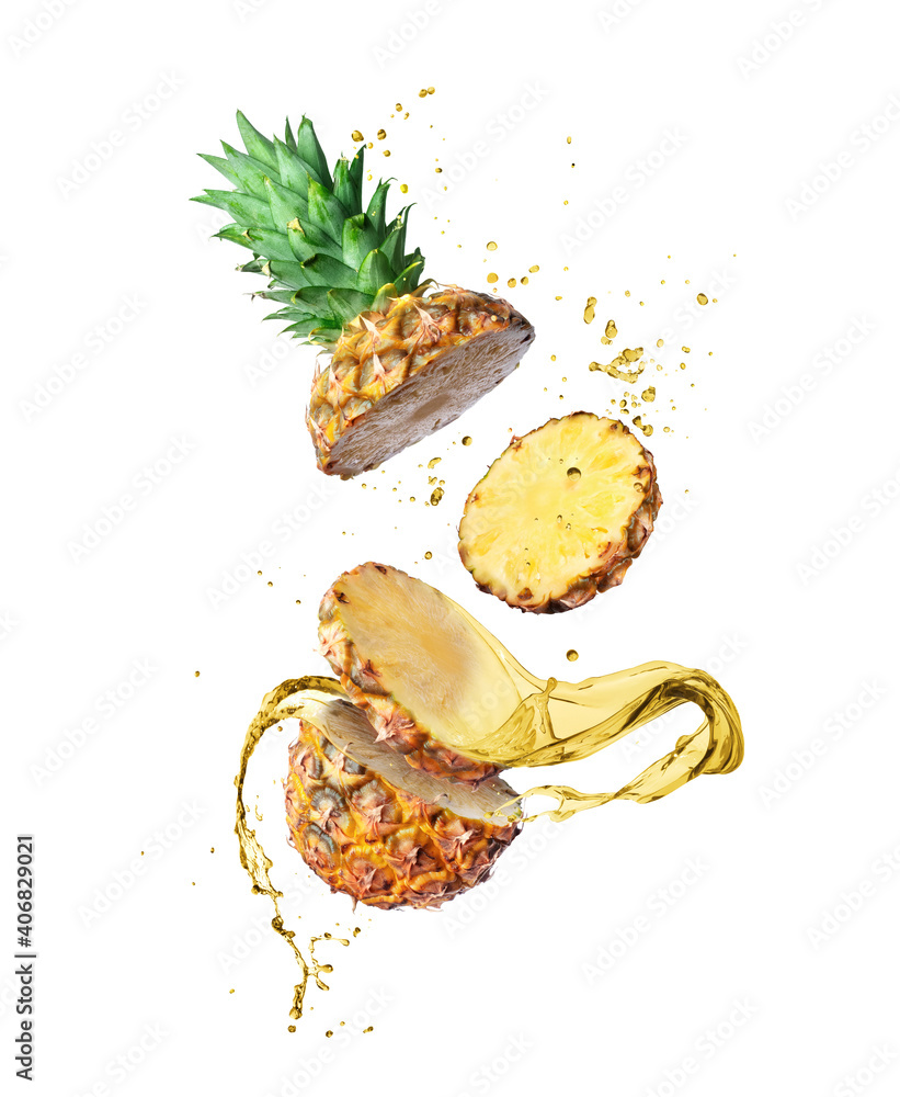 Chopped pineapple with splashes of juice in the air close-up on a white background