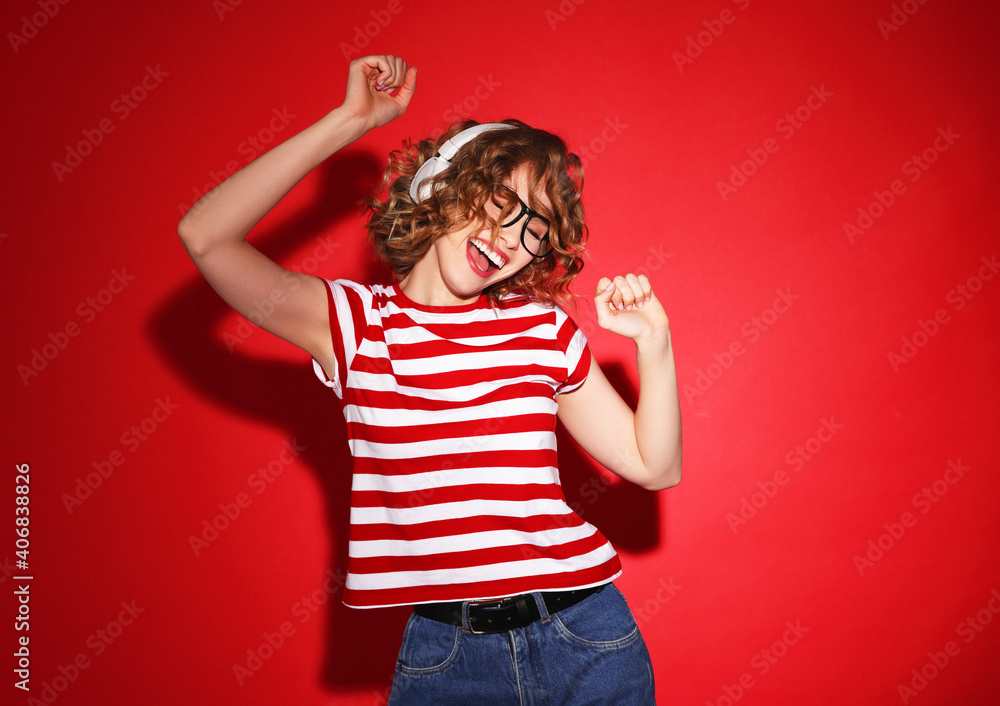 Young woman listening to music and dancing