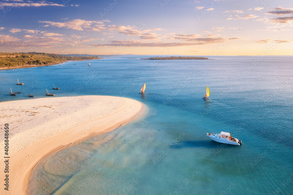 Sailboats and yacht on the sea at sunset in summer. Tropical landscape with boat, white sandy beach,