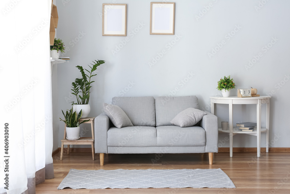 Stylish interior of living room with sofa