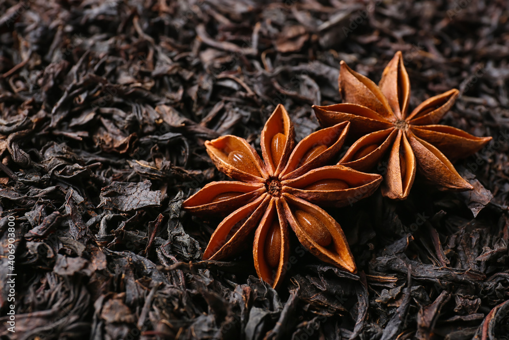 Dry black tea leaves and anise as background