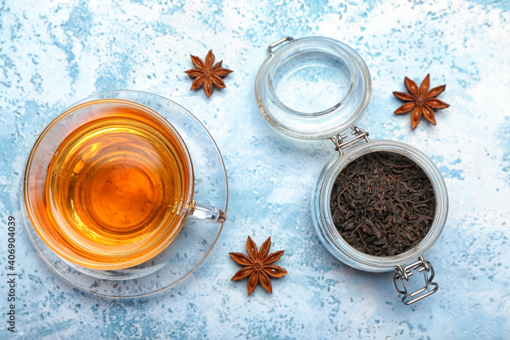 Cup of hot aromatic tea on color background