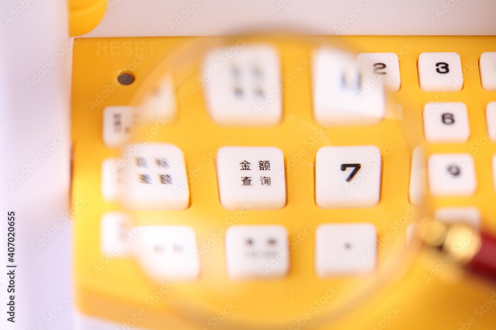 Magnifying glass and ATM keyboard