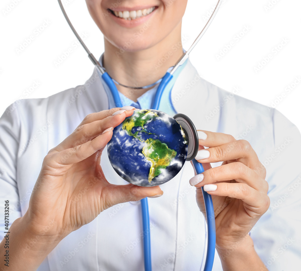 Female doctor with stethoscope and model of Earth on white background. Ecology concept