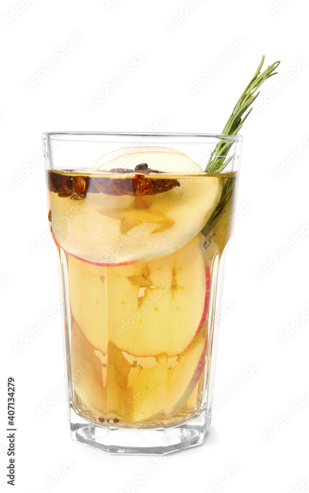 Tasty drink with spices and apple slices in glass on white background