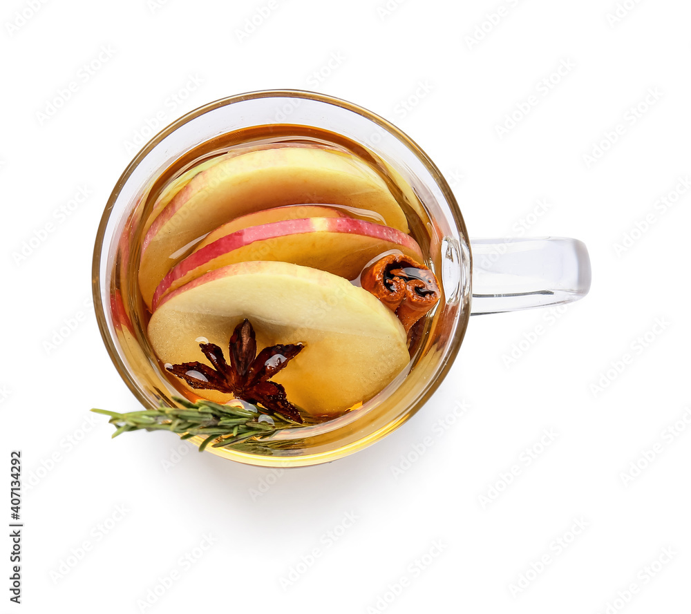 Tasty drink with spices and apple slices in cup on white background