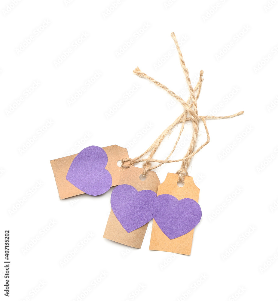 Shopping tags with paper hearts on white background