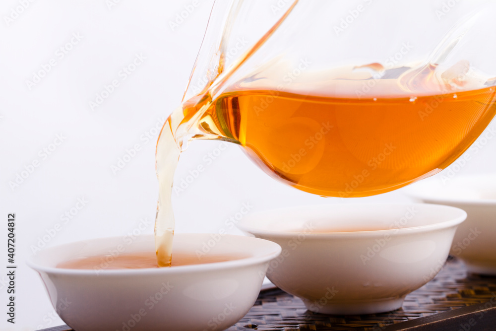 Tea pouring into tea cup