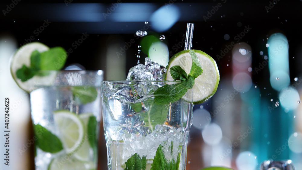 Detail of glass of mojito drink with splashing liquid