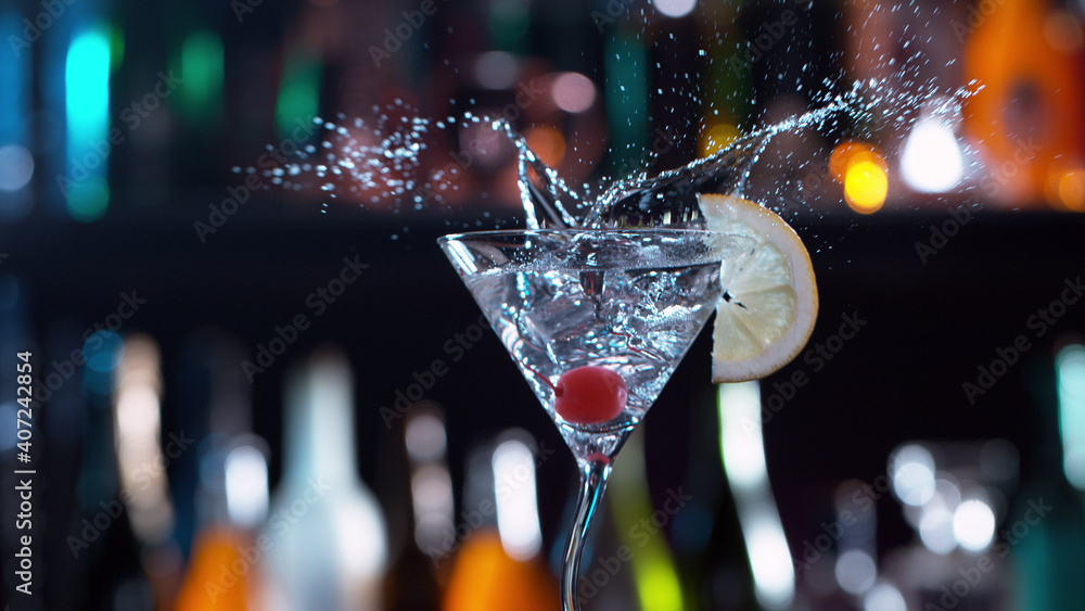 Freeze motion of splashing martini drink in bar