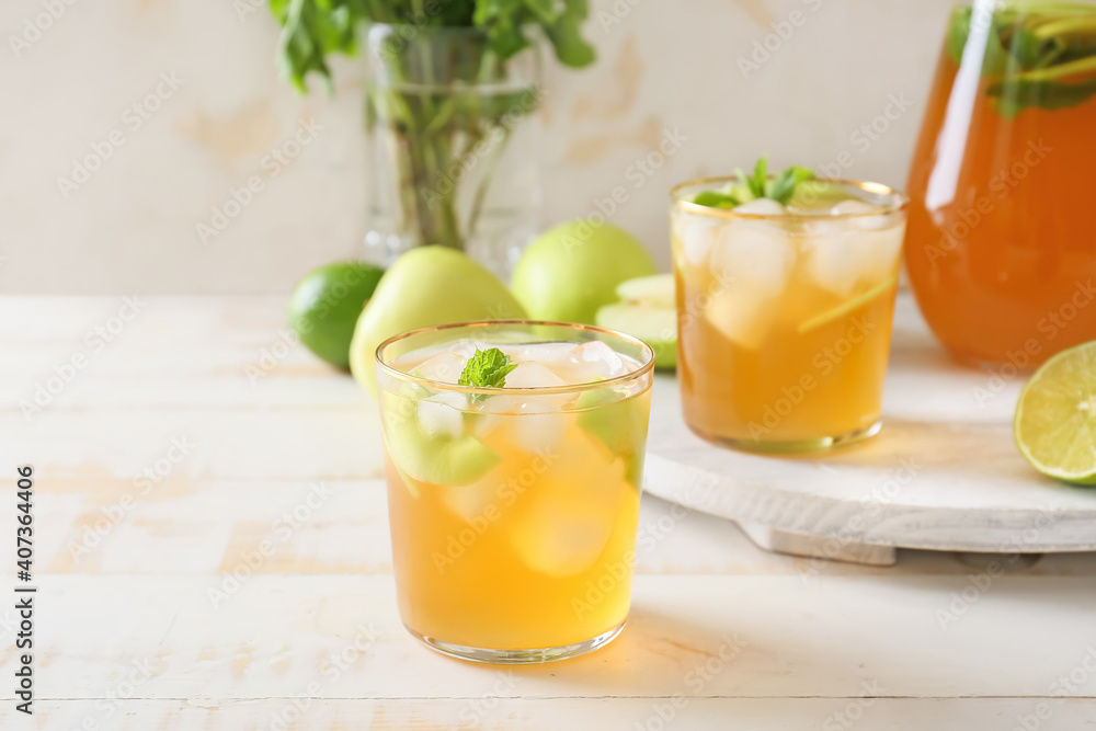 Glasses of tasty ice tea on wooden background