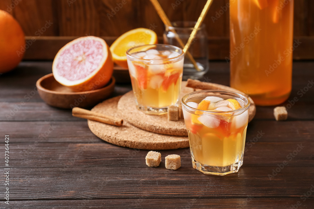 Glasses of tasty ice tea on wooden background