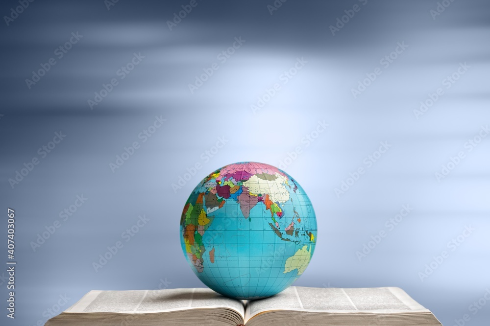 Heavy book and globe planet on background