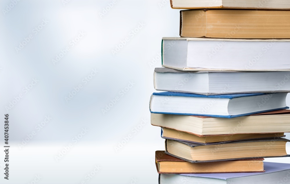 Books collection in pile on light background.