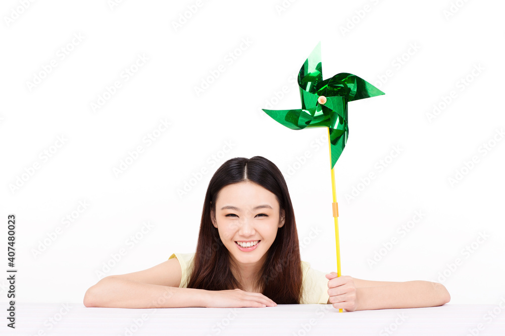 Young woman holding a paper windmill