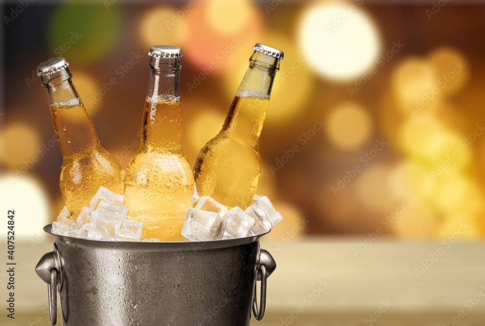 Bottles of cold and fresh beer with ice in the bucket