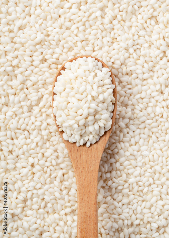 Wooden spoon on top of glutinous rice spread over the entire screen