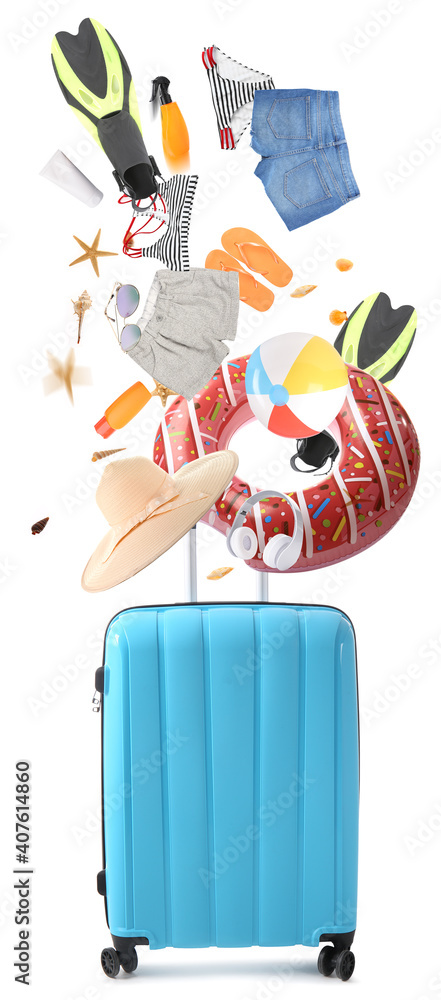 Suitcase with falling beach accessories on white background