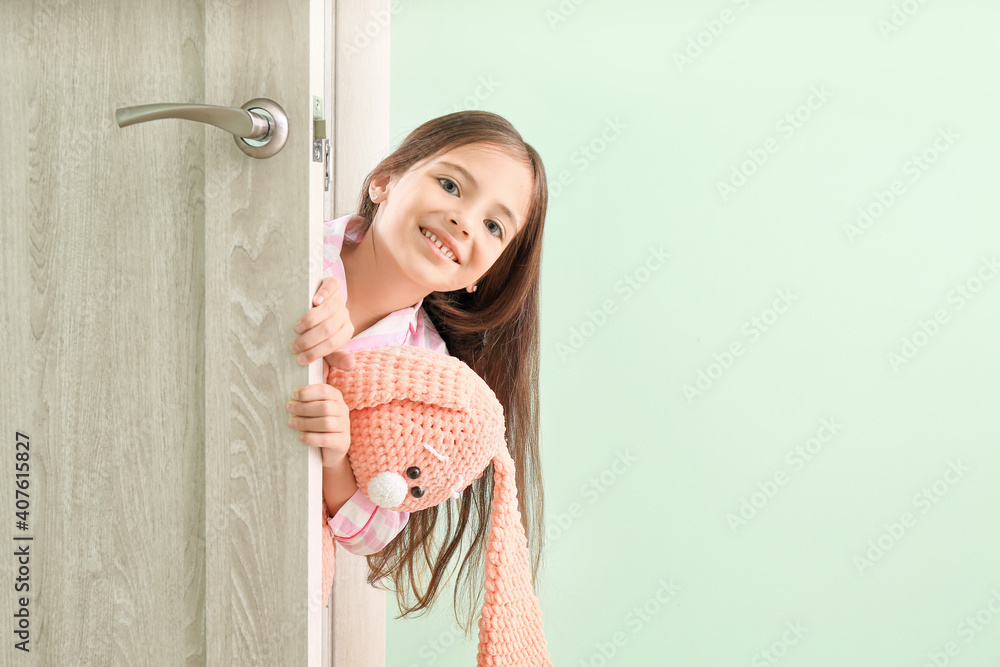 Cute little girl looking out the door