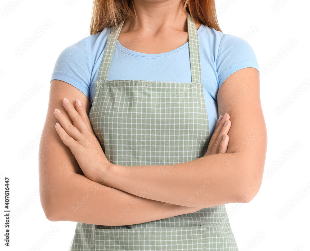 Beautiful young woman wearing apron on white background