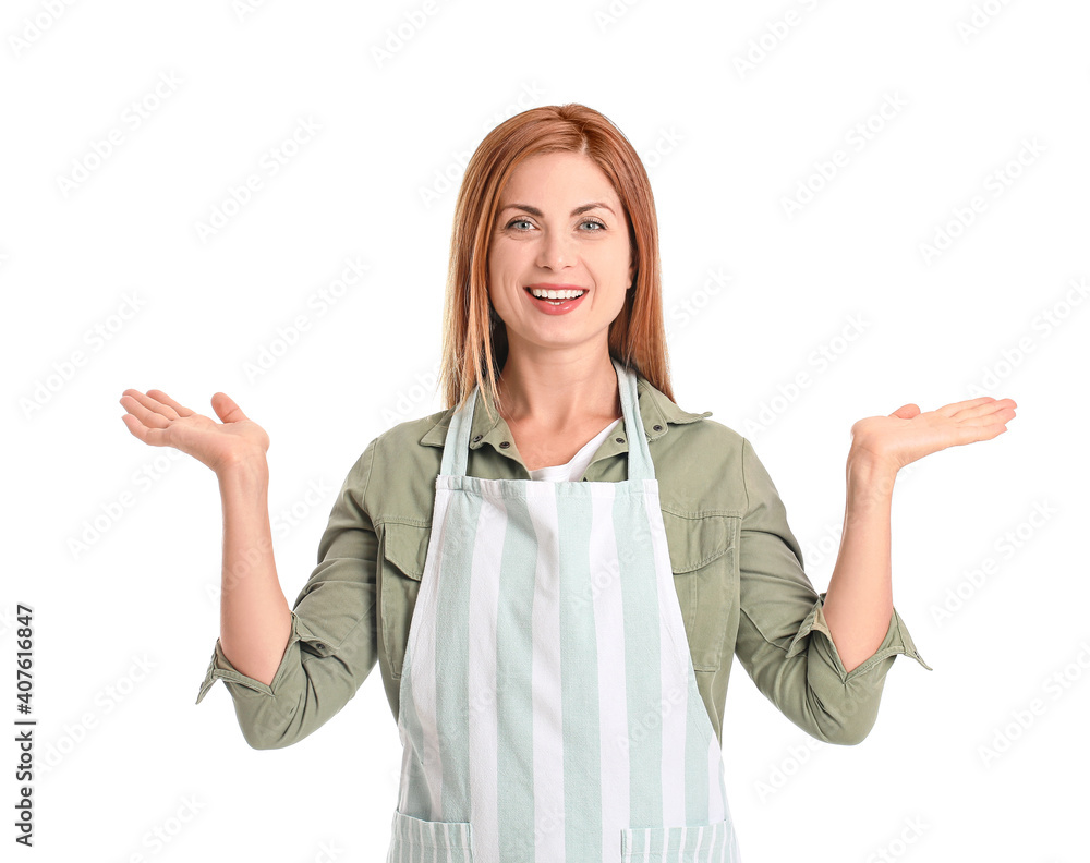 Beautiful young woman showing something on white background