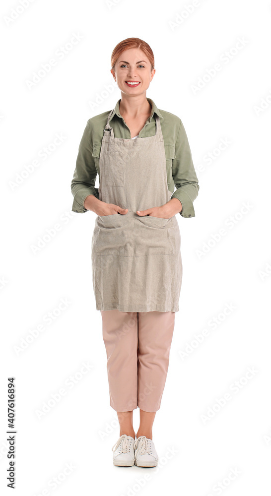 Beautiful young woman wearing apron on white background