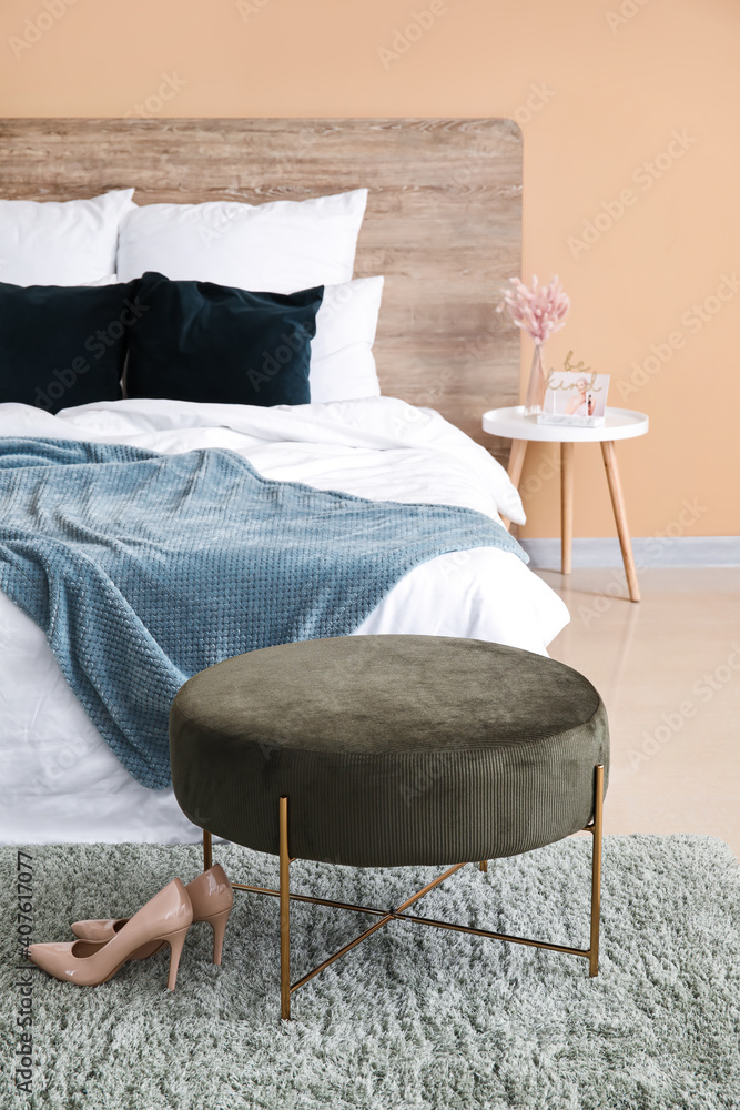 Comfortable bed near color wall