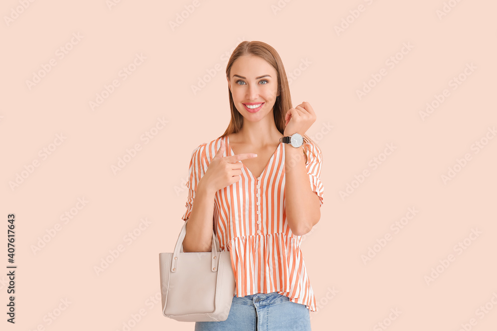 Beautiful woman with wristwatch on color background