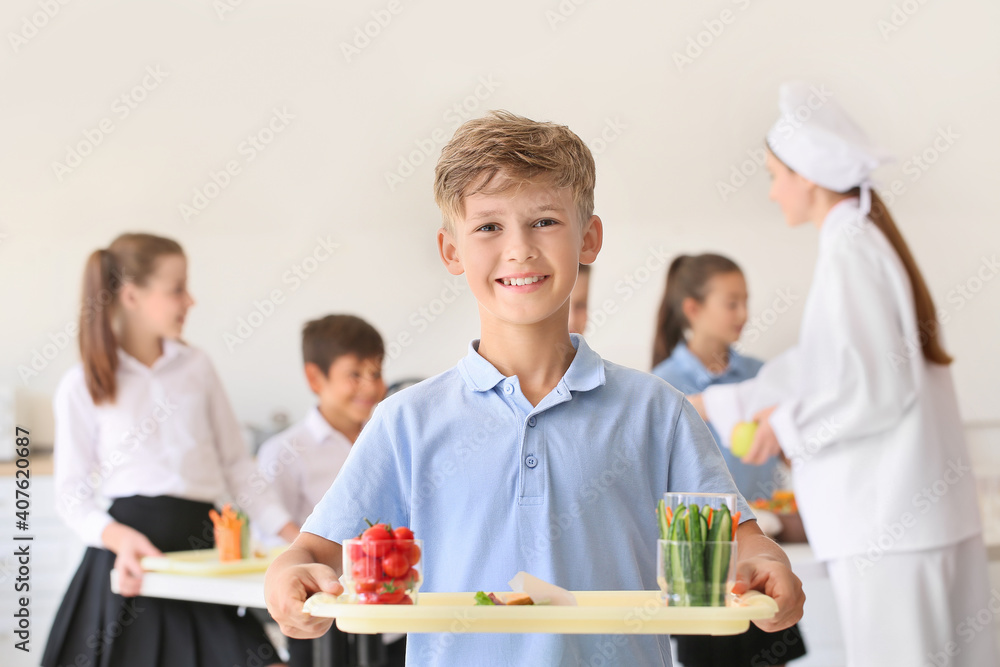 Schoolboy having lunch in school canteen