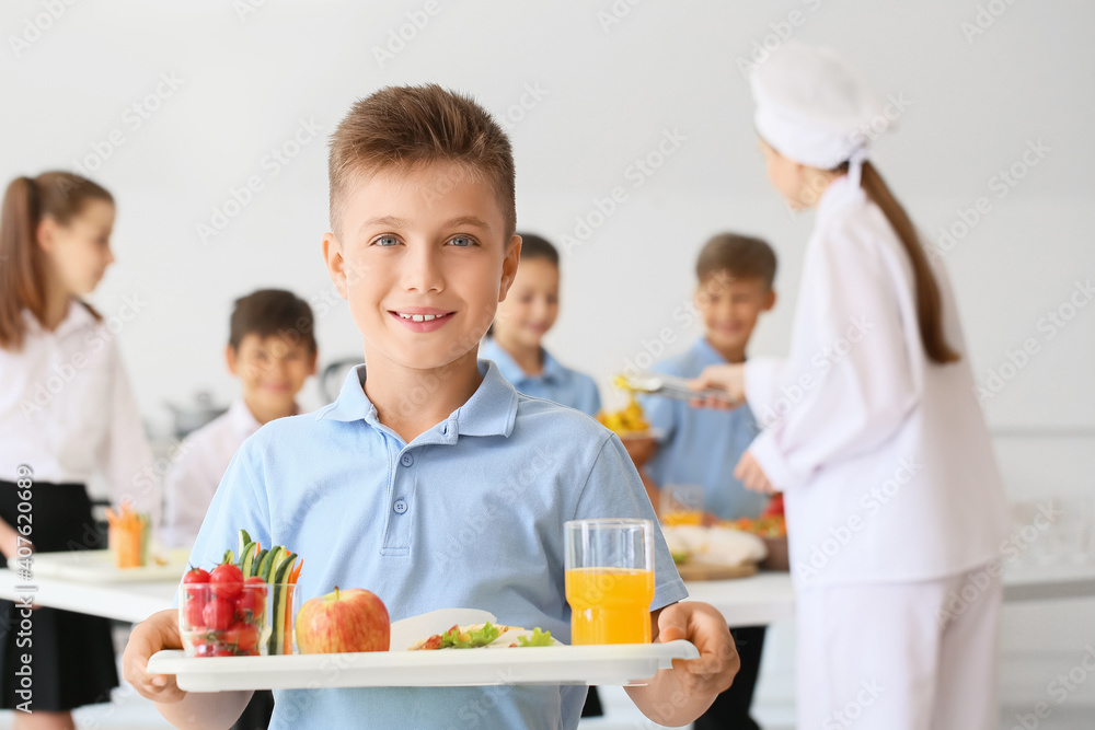 Schoolboy having lunch in school canteen