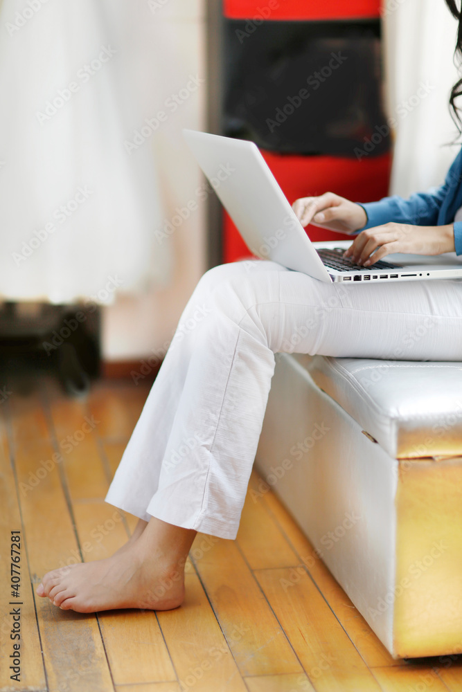 Fashion young woman using a laptop computer