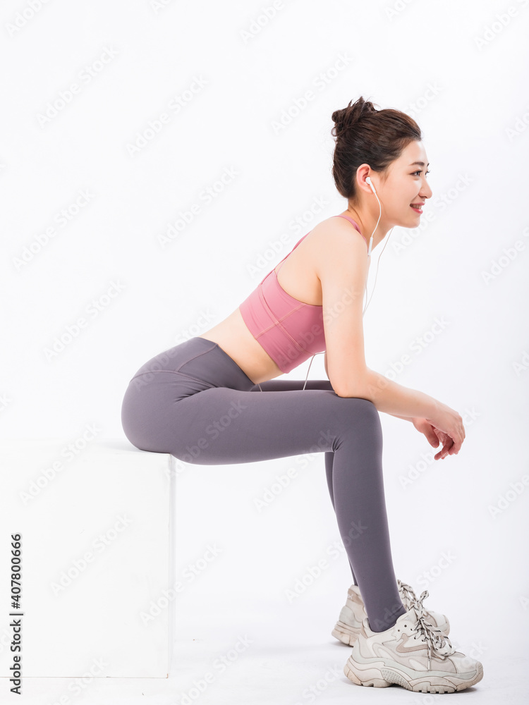 Young women in sports vests relax by listening to music