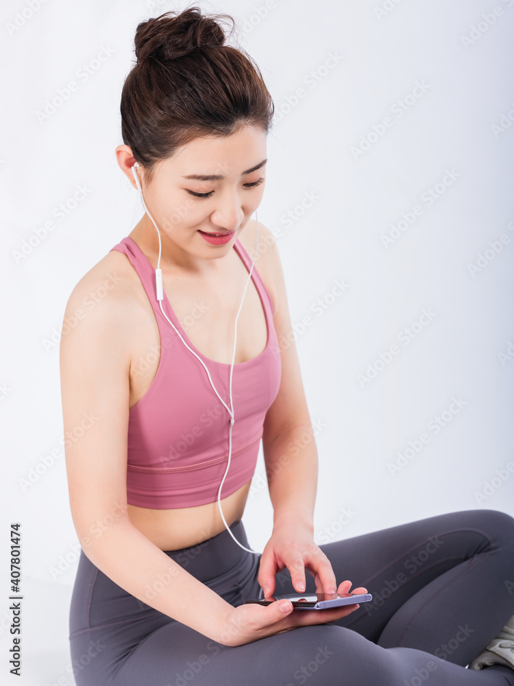 Young women in sports vests relax by listening to music