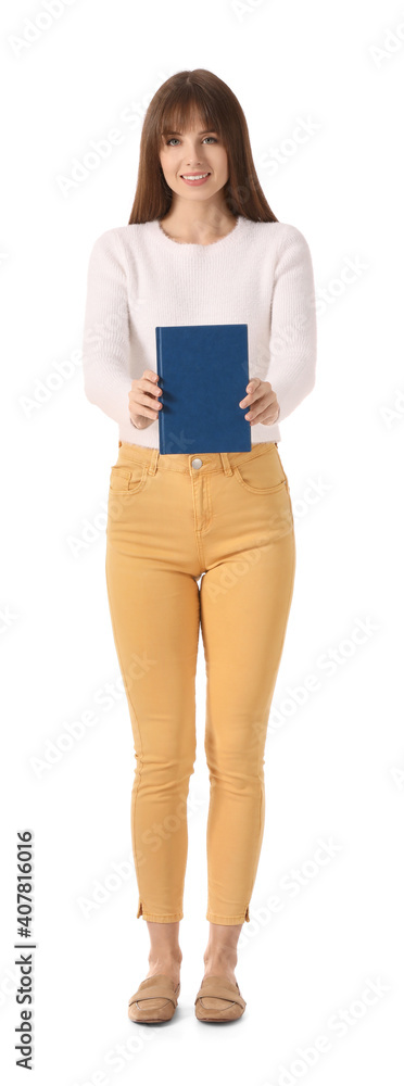 Beautiful young woman with book on white background