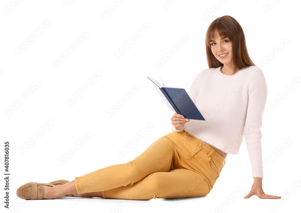 Beautiful young woman reading book on white background