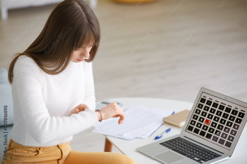 Stressed young woman trying to meet deadline at home