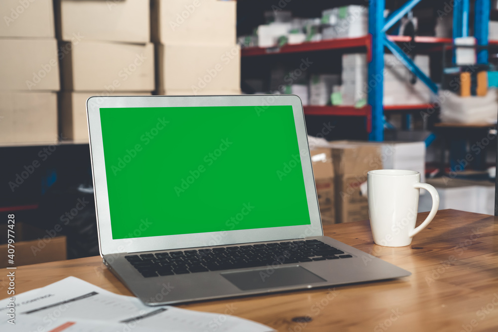 Computer with green screen display in warehouse storage room . Delivery and transportation software 