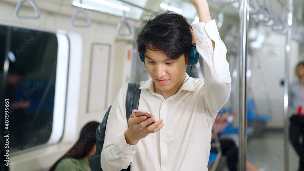 Businessman using mobile phone on public train . Urban city lifestyle commuting concept .