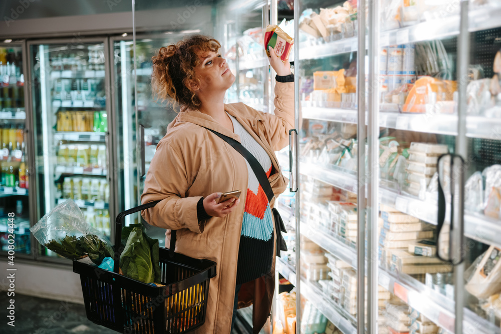 Woman shopping groceries in supermarket