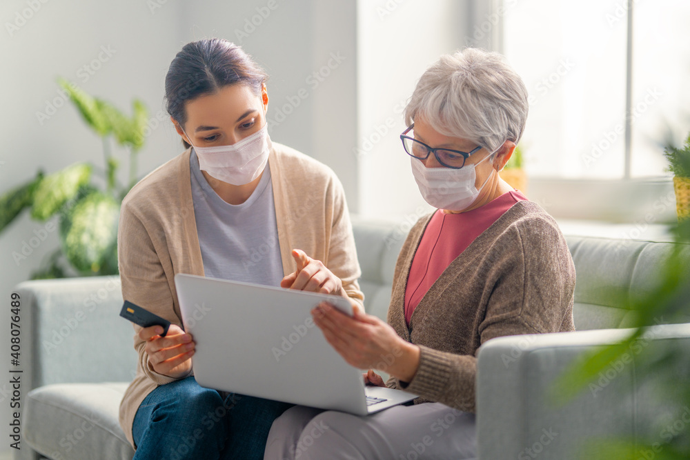 Young and senior women are using laptop