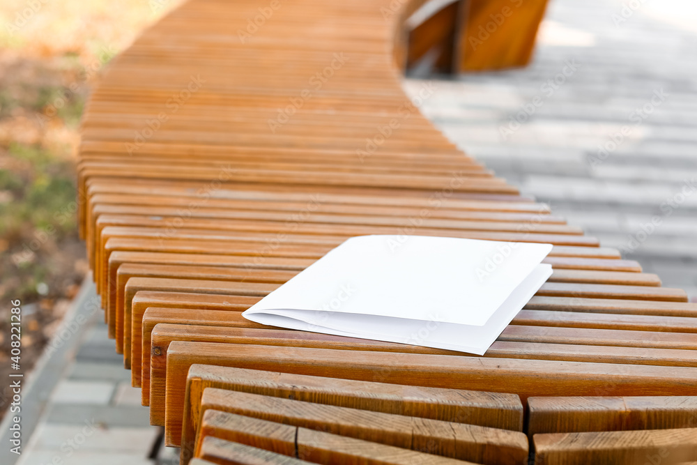 Blank magazine on bench in park