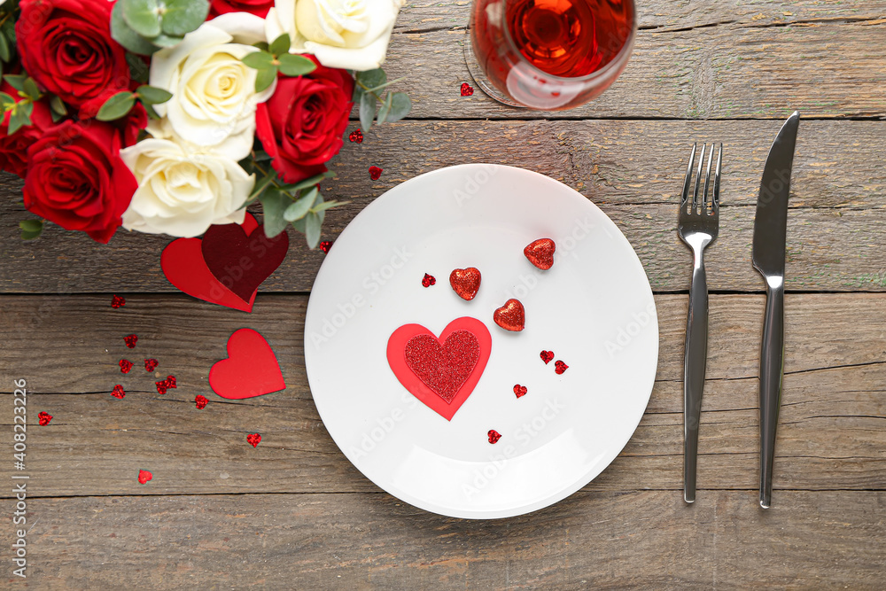 Festive table setting for Valentines Day celebration on wooden background