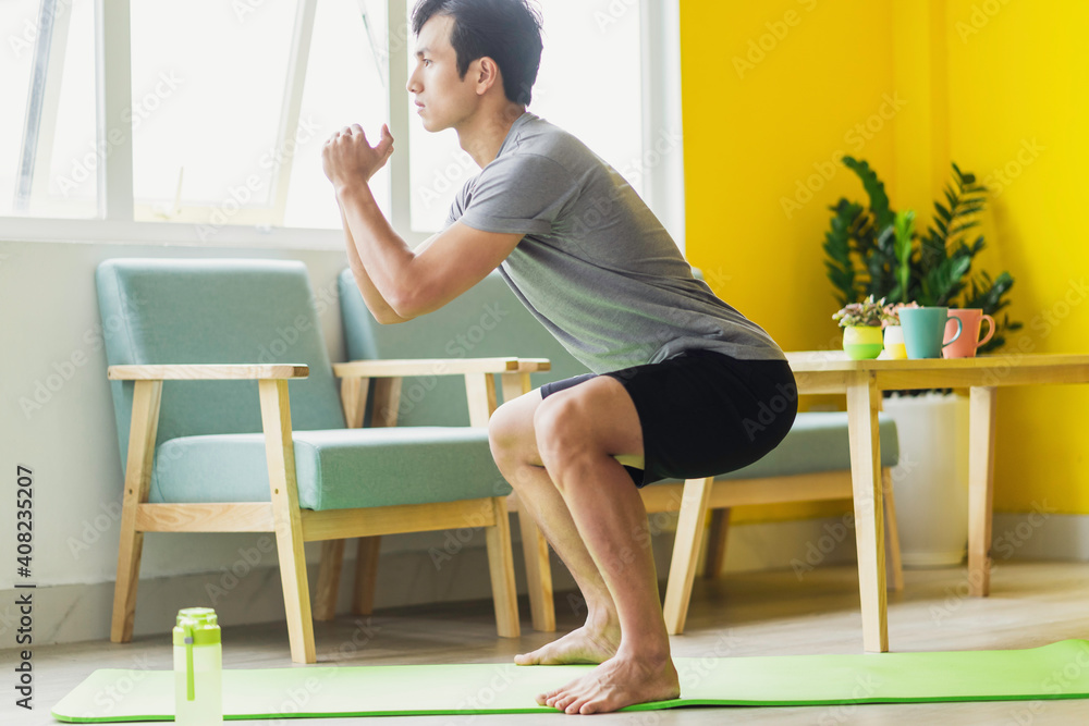 Asian man doing exercise at home