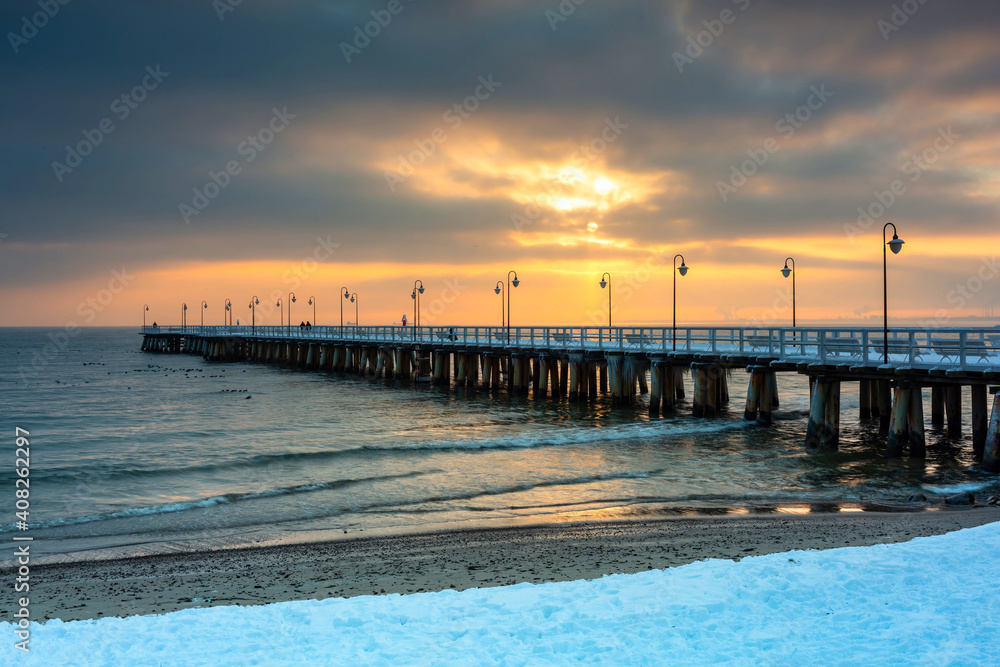 Beautiful wooden pier in Gdynia Orlowo at snowy winter, Baltic Sea. Poland