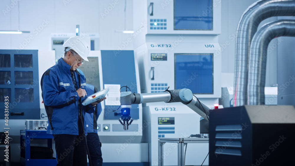 Chief Engineer Wearing Safety Vest and Hard Hat, Use Digital Tablet in Modern Factory, Optimizing Pr